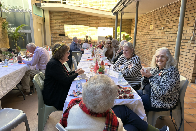 Residents sitting at long table